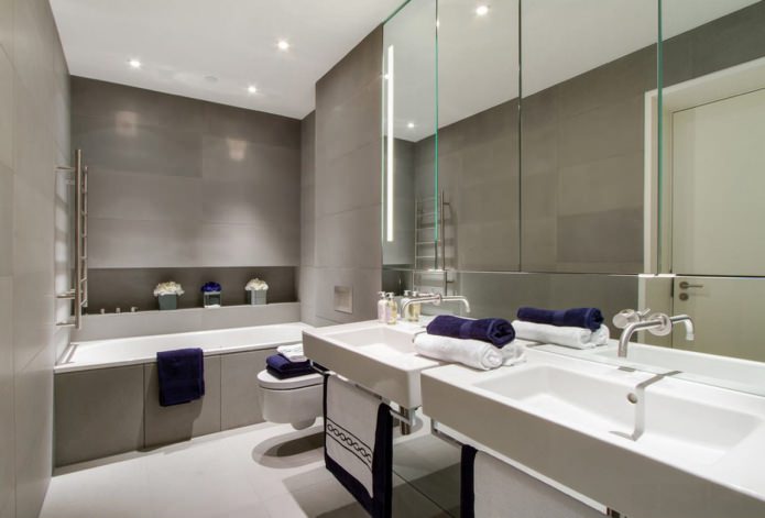 azulejos cinza no banheiro combinado com luminárias brancas