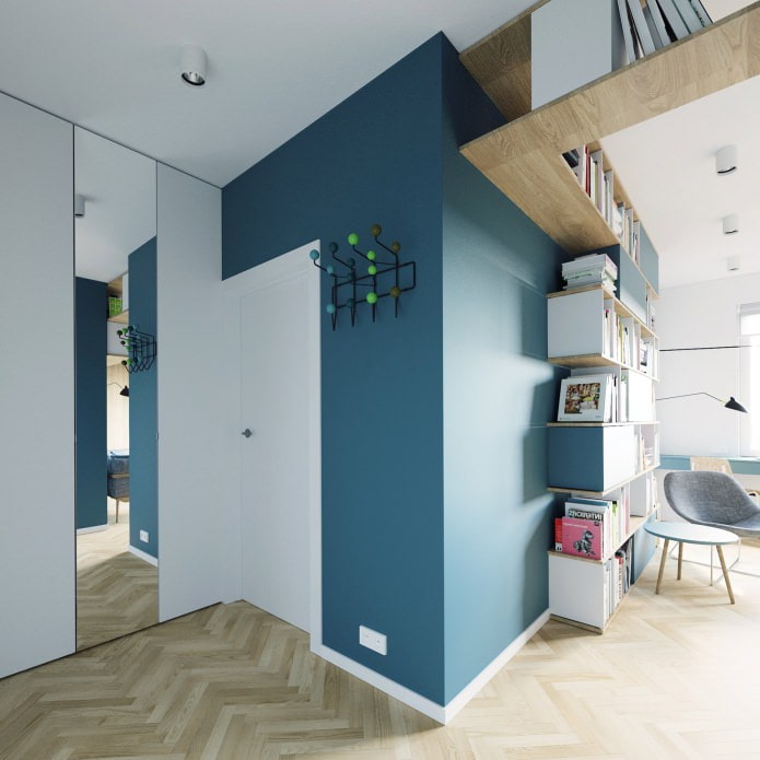 design of the entrance hall in white and turquoise tones in the studio apartment