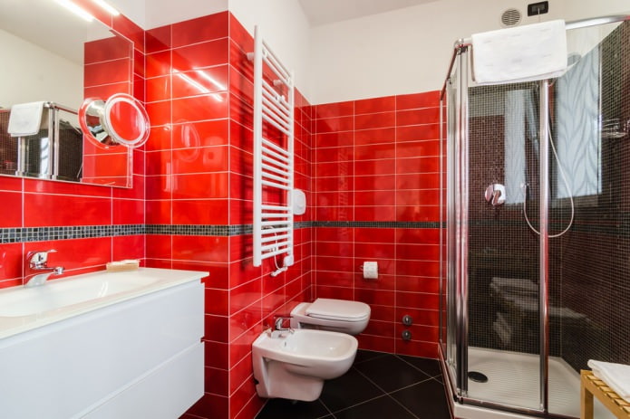red tile on the walls in the bathroom