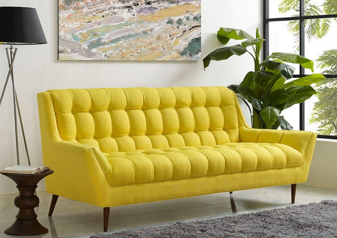 yellow sofa on the legs in the interior