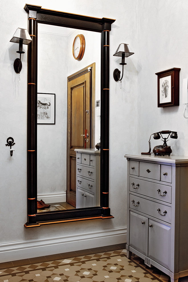 mirror with sconces in the hallway interior