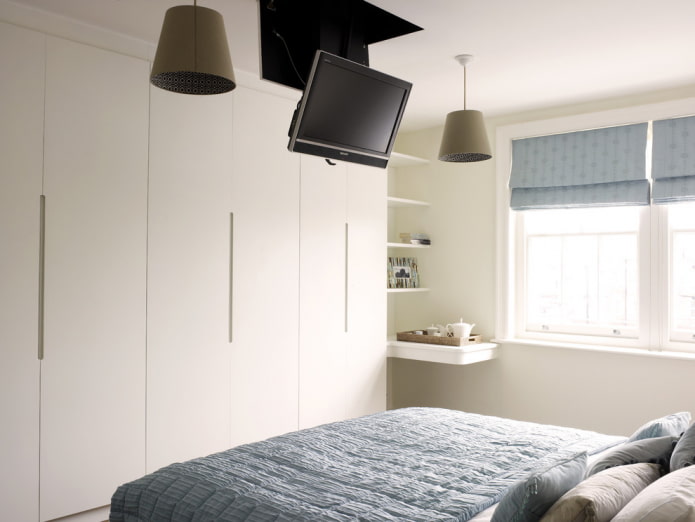 TV on the ceiling in the bedroom interior