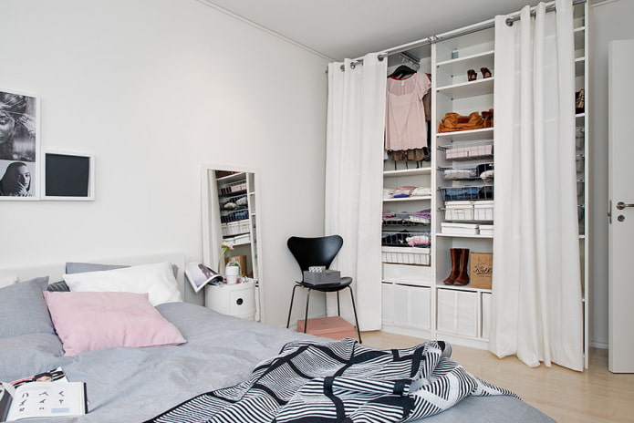 small bedroom with dressing room behind the curtains