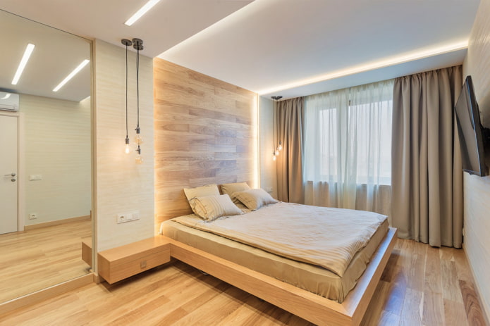 dřevěná postel bez zad v interiéru