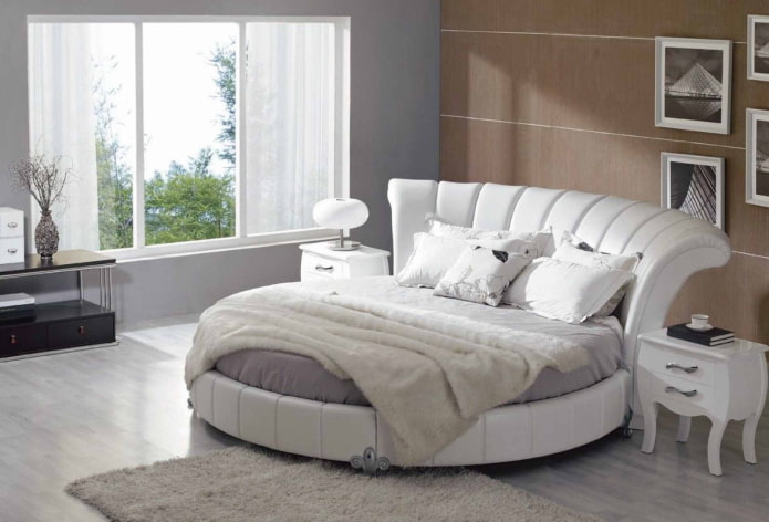 a bed with a curved headboard in the interior