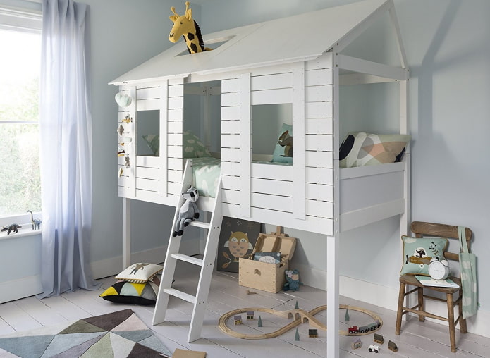 bed in the form of a house with a play area in the nursery