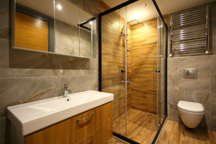 combination of wood-like tiles with marble in the bathroom interior
