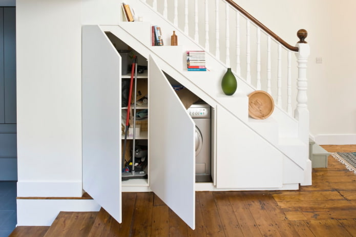 cabinet for household items under a stairwell in the interior