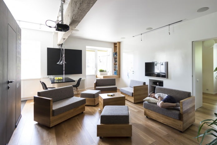 sala de estar no design de um apartamento de três quartos de 80 metros quadrados. m